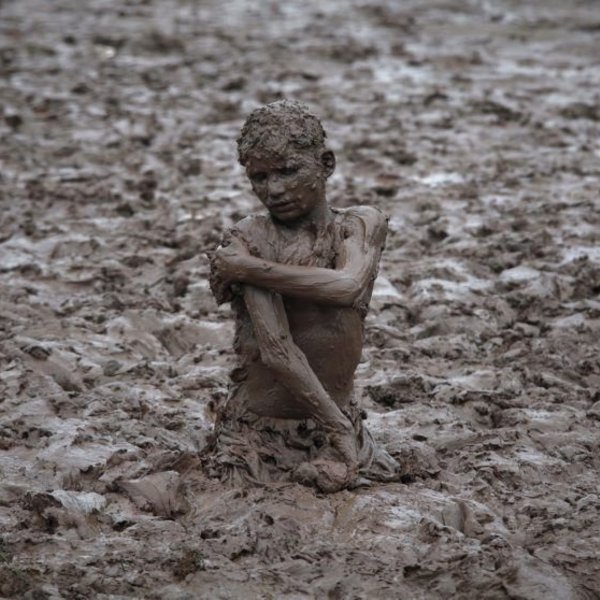 763367 a boy plays in the mud near the ravi river after a downpour on the outskirts of lahore