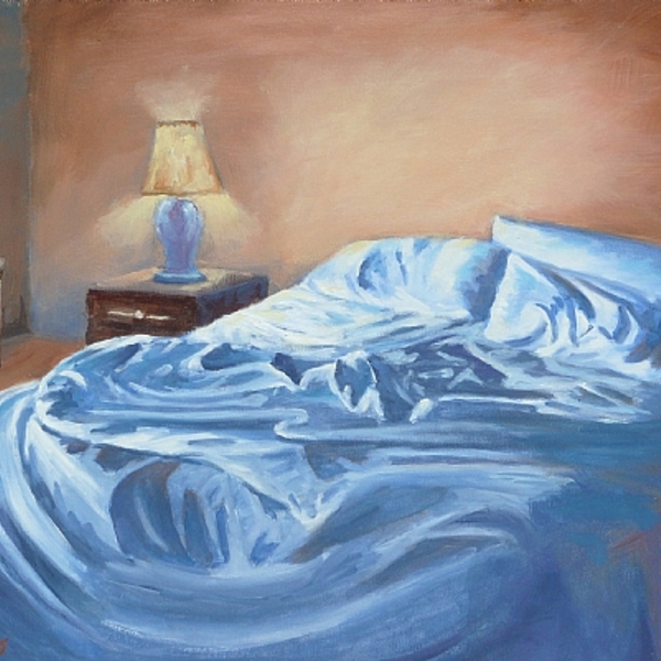 Unmade bed with blue blanket and orange wall