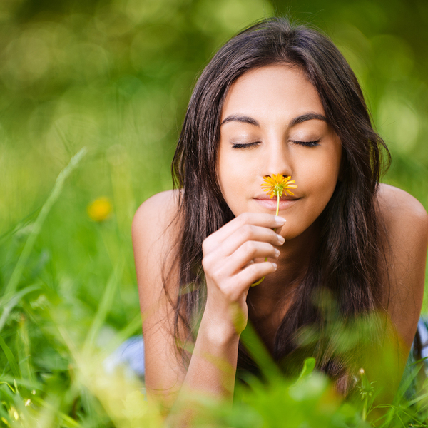 Woman smelling flowers in the field