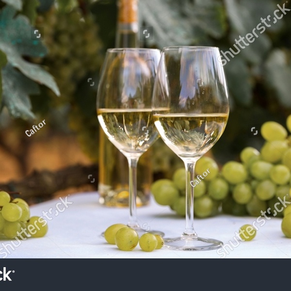 Stock photo glass of white wine and ripe grapes on table in vineyard 2080338595